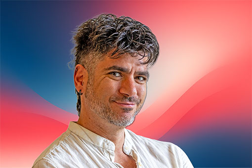 Joel Bondorowsky, expert marketing consultant, smiling in front of branded PPC Designs gradient background.